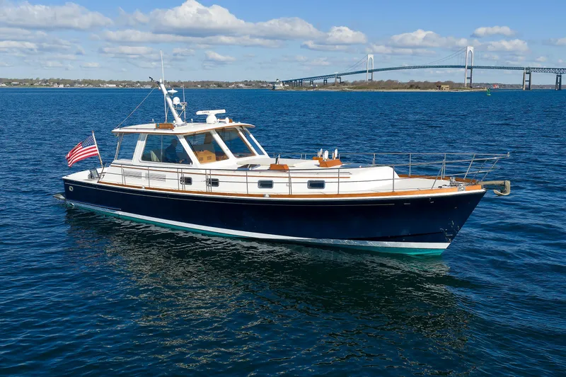 Slide: The Image of Eastbay 49 yacht from 2000 on open water with bridge in background. - 3