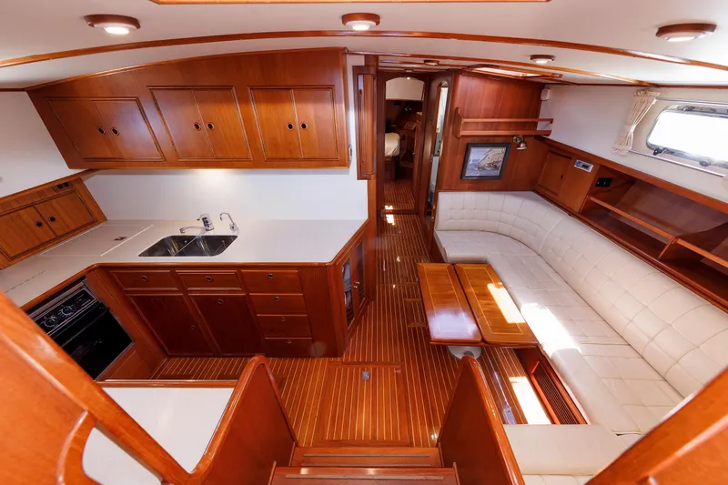 Slide: The Image of Luxurious interior of a 2000 Eastbay 49 yacht with wood finishes and white seating. - 31