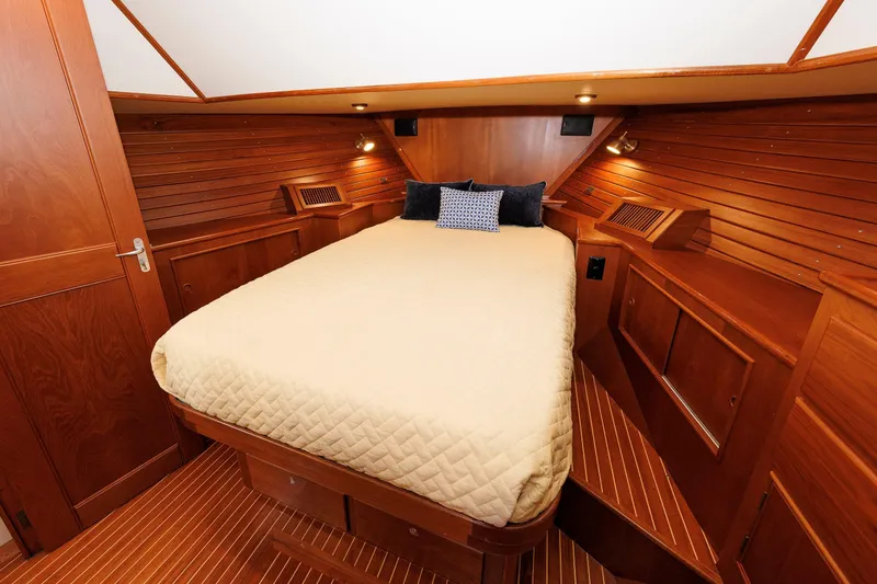 Slide: The Image of Luxurious wooden cabin interior of 2000 Eastbay 49 yacht with cozy bed and ambient lighting. - 34