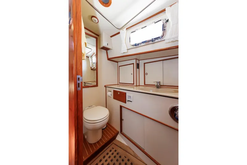 Slide: The Image of Luxurious Eastbay 49 yacht bathroom with wooden accents, mirror, and porthole window, year 2000 model. - 35