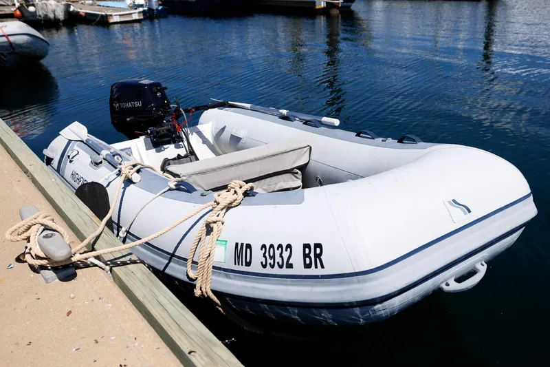 Slide: The Image of Inflatable boat docked with Tohatsu motor, Eastbay 49 model, 2000. - 36