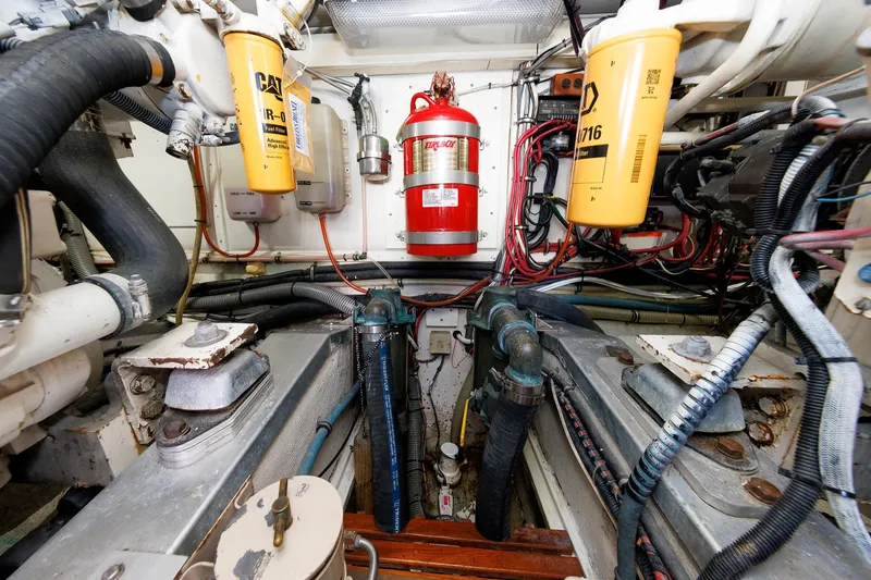 Slide: The Image of Engine room of a 2000 Eastbay 49 boat, featuring filters and fire extinguisher. - 38