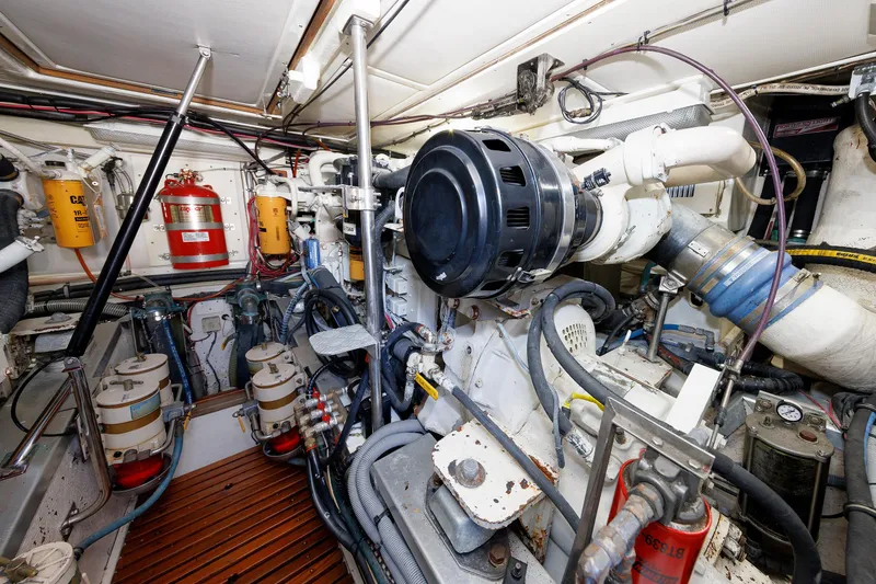 Slide: The Image of Engine room of a 2000 Eastbay 49 yacht, showcasing complex machinery and equipment. - 39
