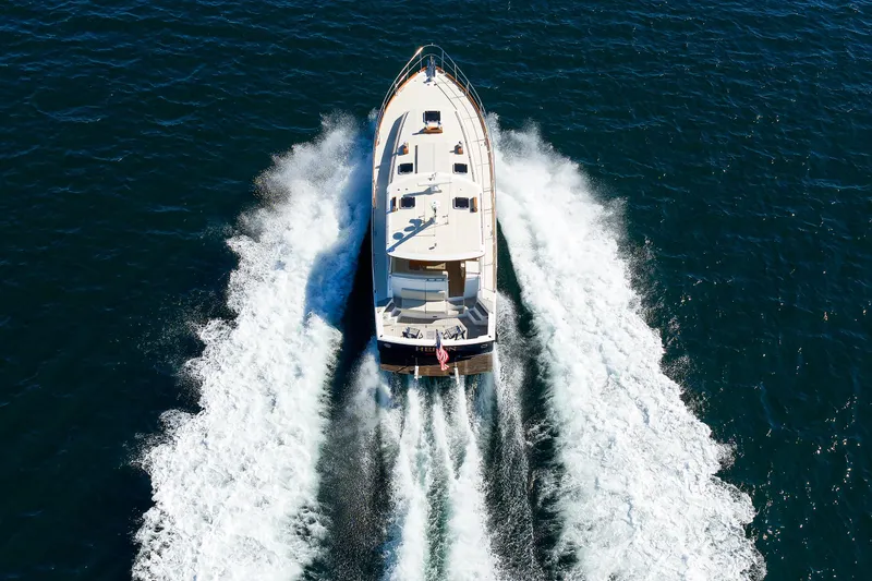 Slide: The Image of Aerial view of 2000 Eastbay 49 yacht cruising on open water. - 4