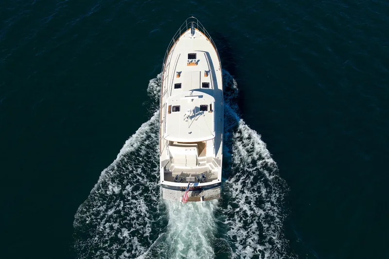 Slide: The Image of Aerial view of 2000 Eastbay 49 yacht cruising on open water. - 5
