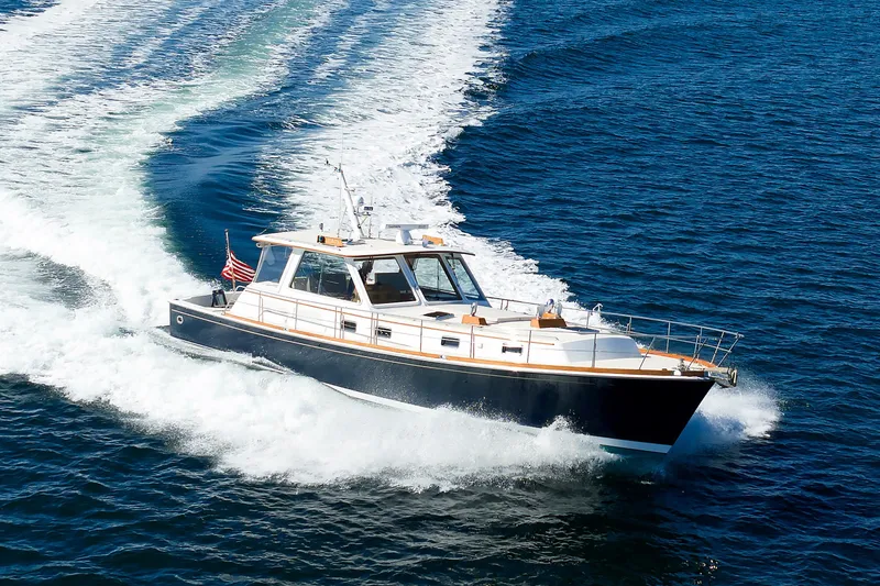 Slide: The Image of Eastbay 49 yacht cruising on open water, 2000 model, leaving a wake behind. - 6