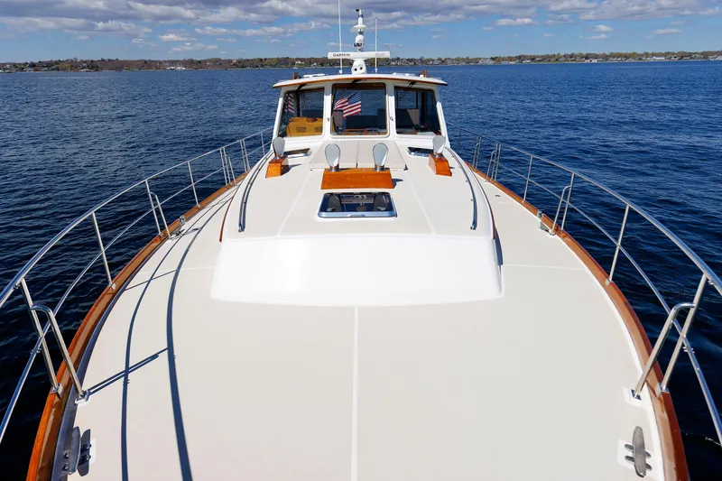 Slide: The Image of Eastbay 49 yacht from 2000 on calm blue waters under a partly cloudy sky. - 9