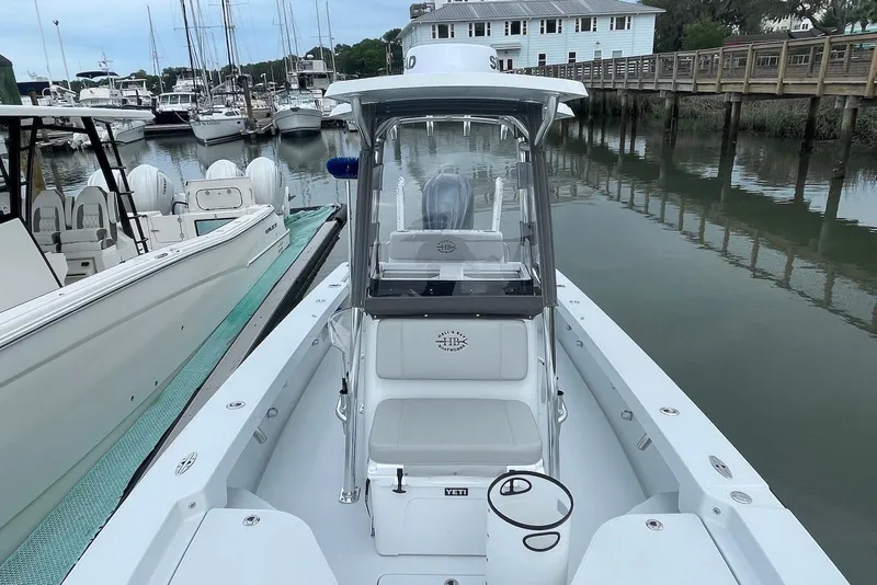Slide: The Image of 2025 Hell's Bay Estero boat docked in a marina, showcasing sleek design and modern features. - 11