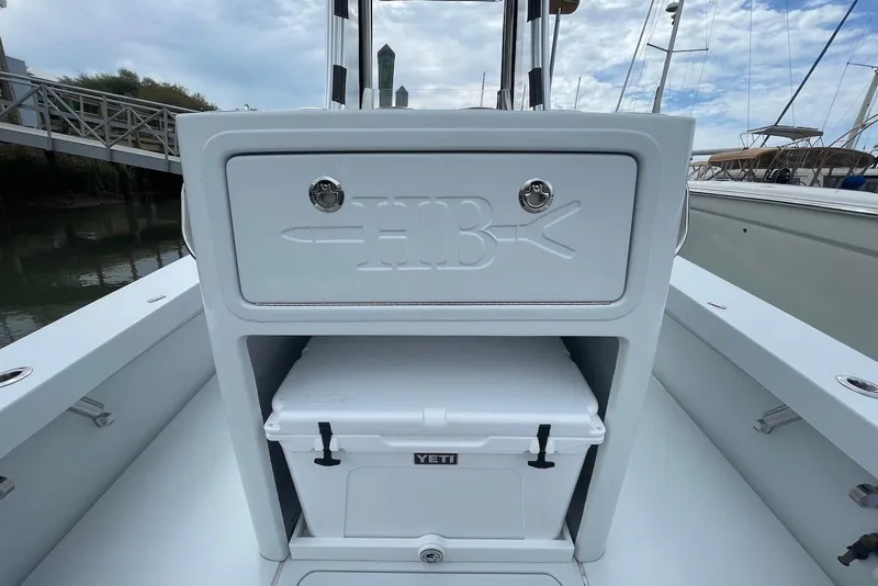 Slide: The Image of 2025 Hell's Bay Estero boat interior with storage compartment and Yeti cooler. - 14