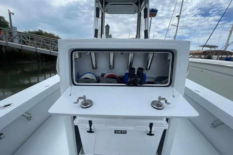 Slide: The Image of 2025 Hell's Bay Estero boat with storage compartment and Yeti cooler on deck. - 15