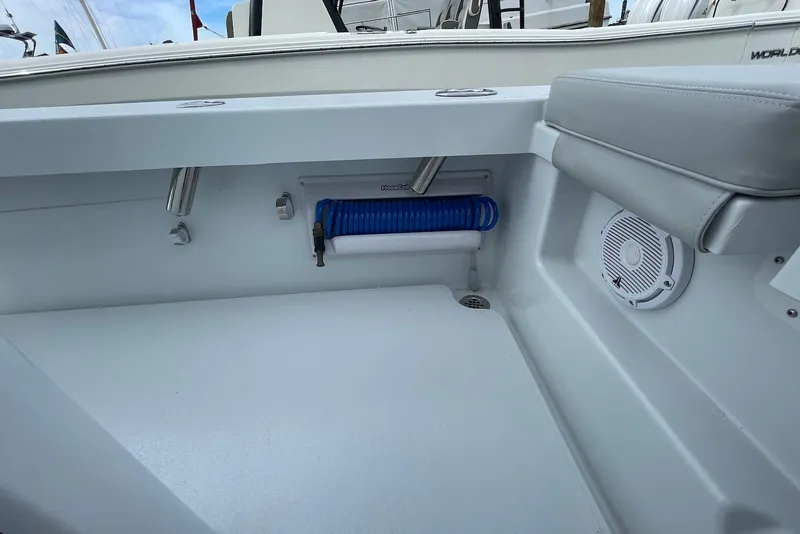 Slide: The Image of 2025 Hell's Bay Estero boat interior with coiled hose and speaker. - 17