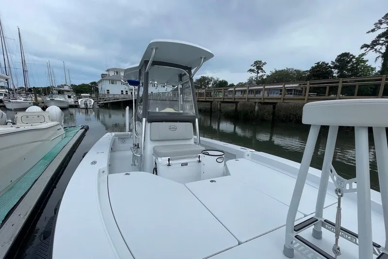 Slide: The Image of 2025 Hell's Bay Estero boat docked in a marina, showcasing sleek design and modern features. - 5