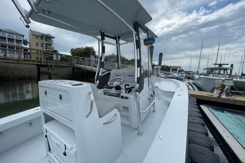 Slide: The Image of 2025 Hell's Bay Estero boat docked at marina, showcasing sleek design and modern features. - 7
