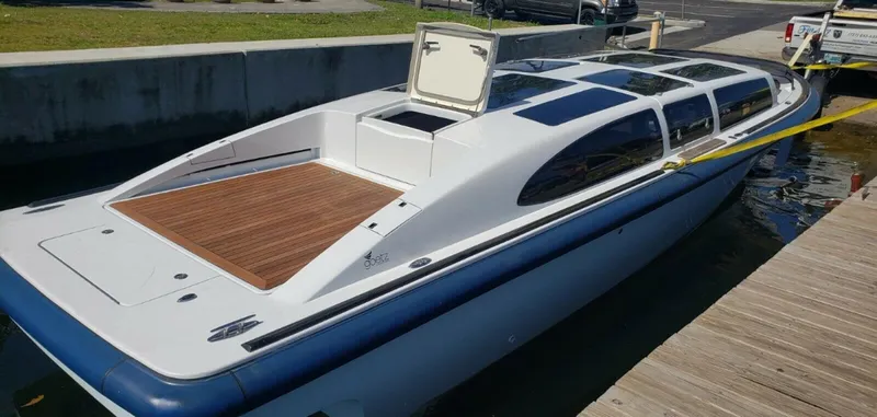 Slide: The Image of 2008 Goetz Custom Boats 33' Limo Tender docked, featuring sleek design and spacious deck. - 1