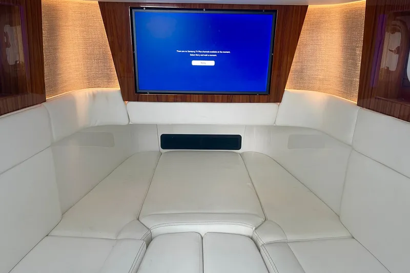 Slide: The Image of Luxurious interior of 2024 HCB 48 Campeon yacht with plush seating and a large screen. - 23