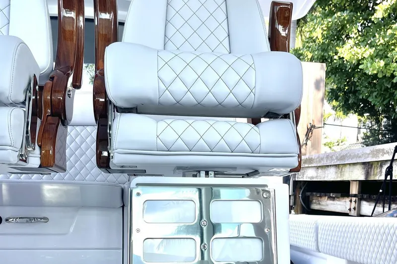 Slide: The Image of Luxurious seating on 2024 HCB 48 Campeon boat with quilted upholstery and wooden accents. - 13