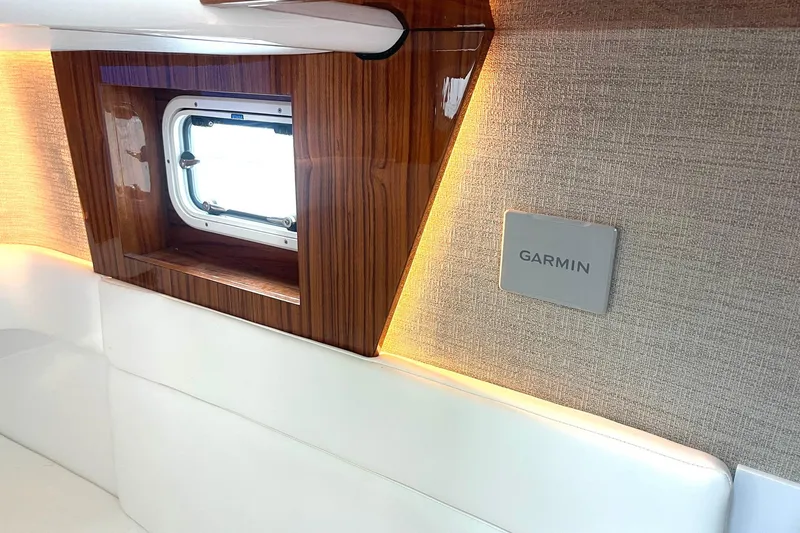 Slide: The Image of 2024 HCB 48 Campeon interior with wood accents, window, and Garmin panel. - 22