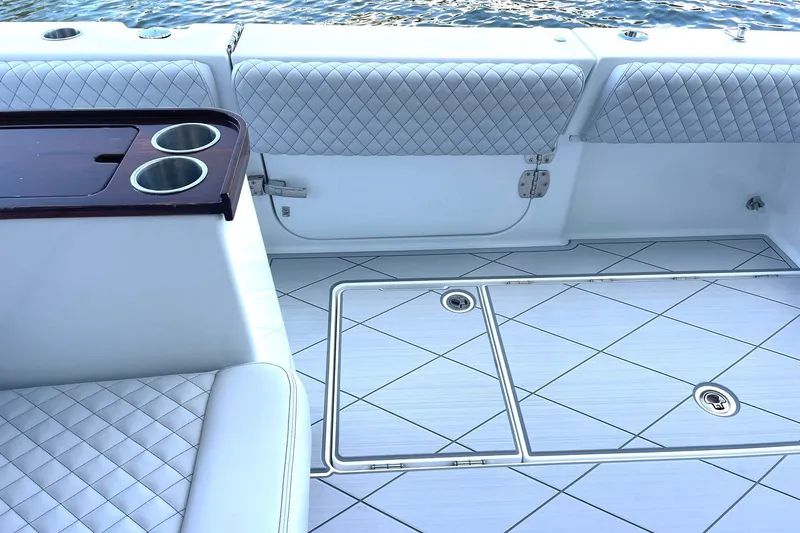 Slide: The Image of Luxurious interior of 2024 HCB 48 Campeon boat with quilted seating and cup holders. - 16