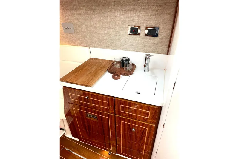 Slide: The Image of Luxurious 2024 HCB 48 Campeon yacht interior with elegant wood cabinetry and modern sink. - 25