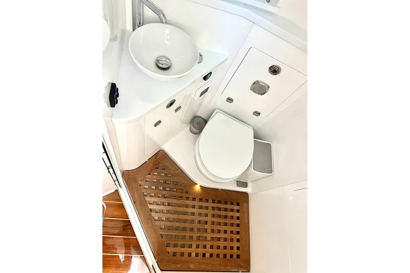 Slide: The Image of Luxurious bathroom in 2024 HCB 48 Campeon boat with modern fixtures and wooden flooring. - 24