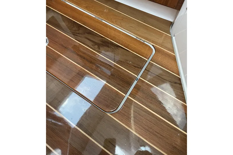 Slide: The Image of Polished wooden deck of 2024 HCB 48 Campeon boat, featuring sleek design. - 18