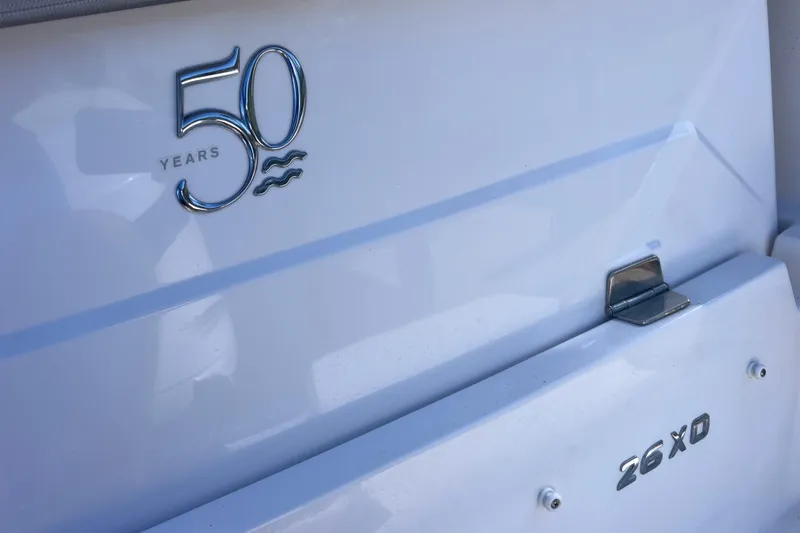 Slide: The Image of 2020 Regal 26 XO boat, 50th anniversary emblem, white exterior detail. - 12