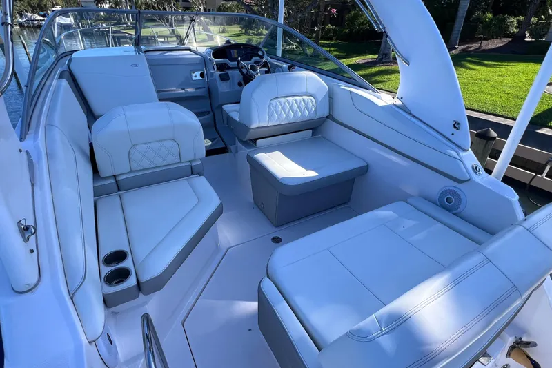 Slide: The Image of 2020 Regal 26 XO boat interior with white seating and modern dashboard. - 13