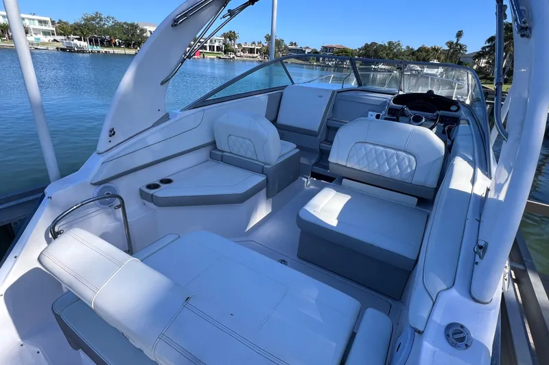 Slide: The Image of 2020 Regal 26 XO boat interior with white seating and steering console. - 14
