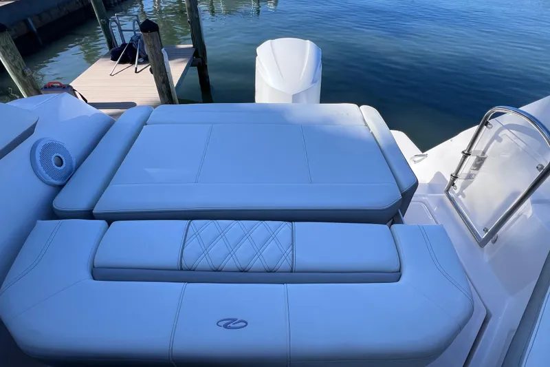 Slide: The Image of 2020 Regal 26 XO boat with luxurious seating and water view. - 16