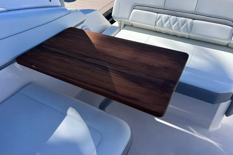 Slide: The Image of Luxury seating area with wooden table on 2020 Regal 26 XO boat. - 18