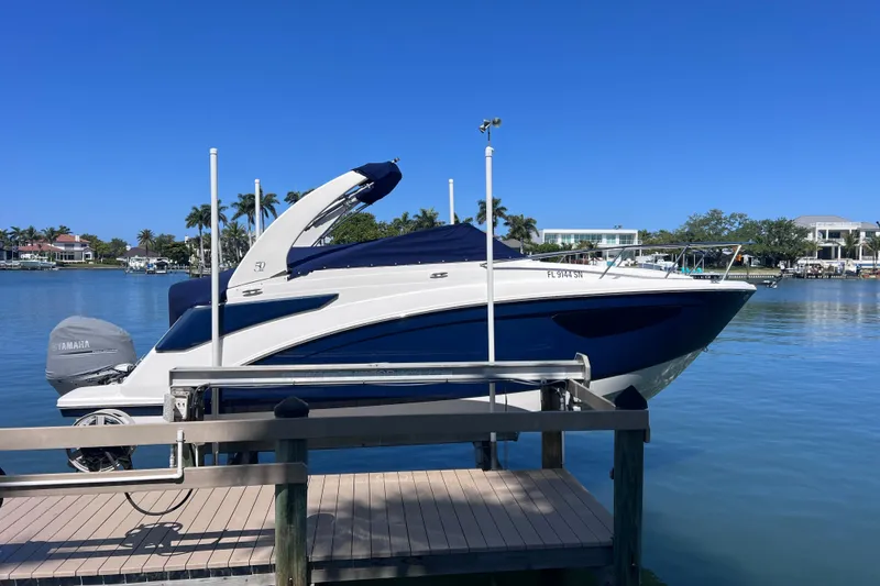 Slide: The Image of 2020 Regal 26 XO boat docked on a sunny waterfront with clear blue skies. - 2