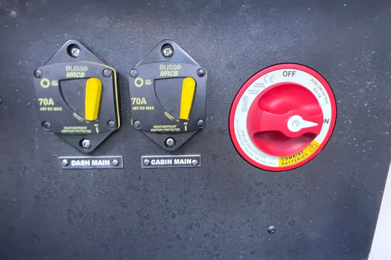 Slide: The Image of Electrical panel of a 2020 Regal 26 XO boat with circuit breakers and battery switch. - 23