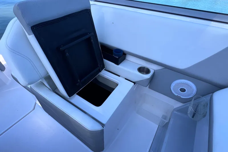 Slide: The Image of 2020 Regal 26 XO boat interior with storage compartment and cup holders. - 24