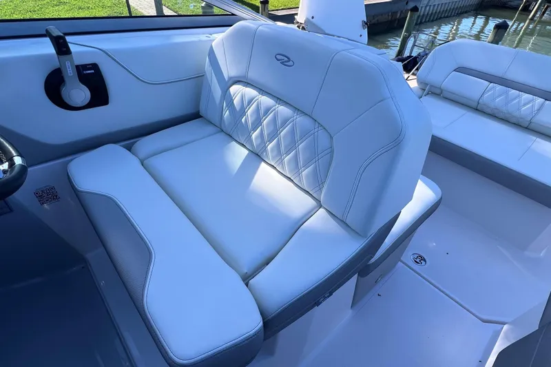 Slide: The Image of Luxurious seating on a 2020 Regal 26 XO boat, featuring white upholstery and elegant design. - 26