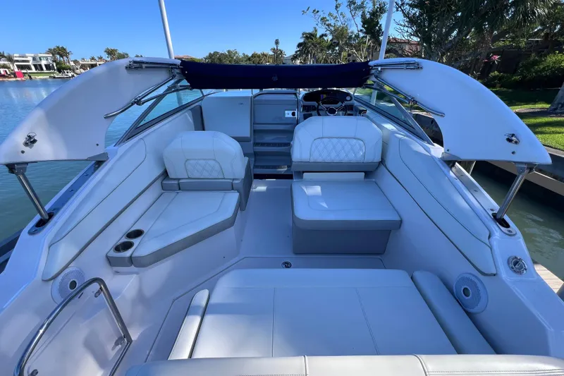 Slide: The Image of 2020 Regal 26 XO boat interior with white seating and open canopy. - 30