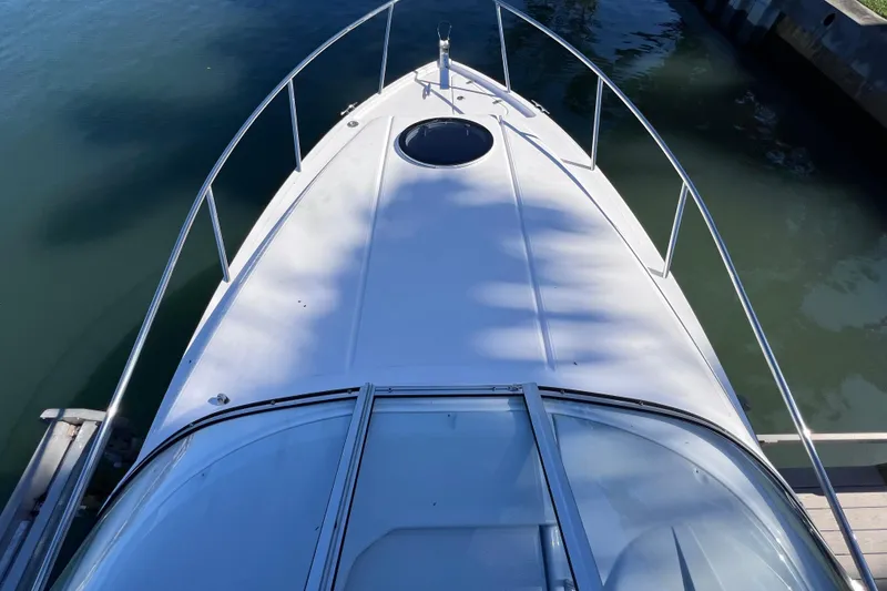 Slide: The Image of 2020 Regal 26 XO boat bow view, docked on calm water. - 32