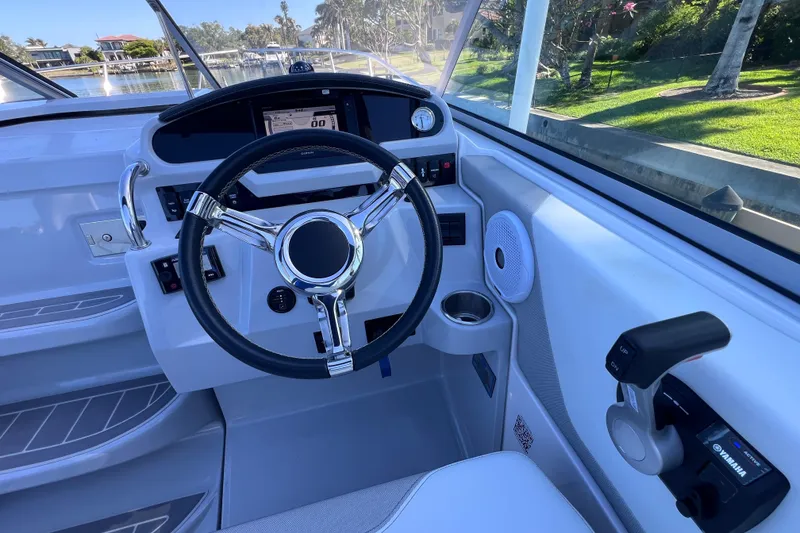 Slide: The Image of Cockpit of 2020 Regal 26 XO boat with steering wheel and control panel. - 34