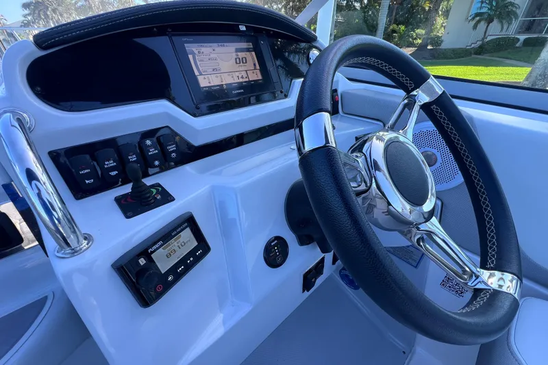 Slide: The Image of 2020 Regal 26 XO boat dashboard with steering wheel and control panel. - 36