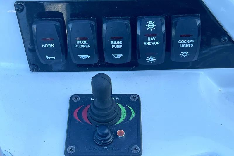 Slide: The Image of Control panel of a 2020 Regal 26 XO boat with various switches. - 37