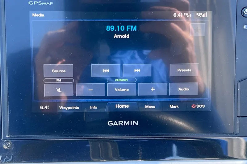 Slide: The Image of Garmin GPS display on 2020 Regal 26 XO boat showing FM radio station. - 43