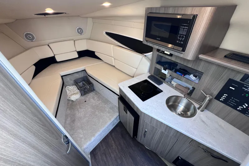 Slide: The Image of Interior of 2020 Regal 26 XO boat with kitchenette and seating area. - 44