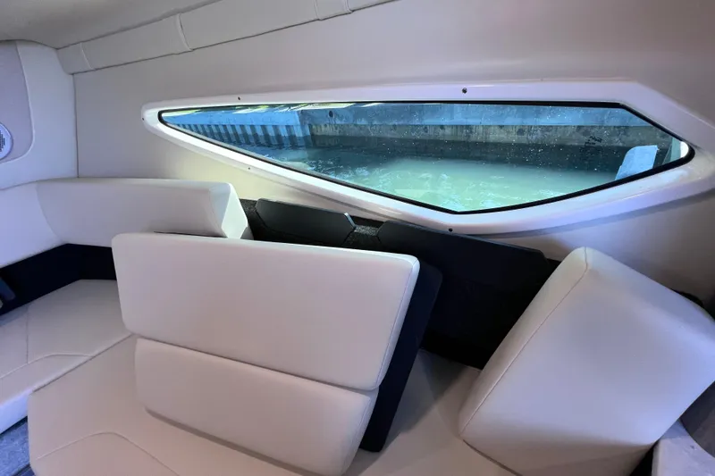 Slide: The Image of Interior of 2020 Regal 26 XO boat with white seating and window view. - 47