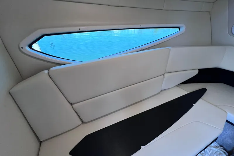 Slide: The Image of Interior of 2020 Regal 26 XO boat with cushioned seating and window view. - 48