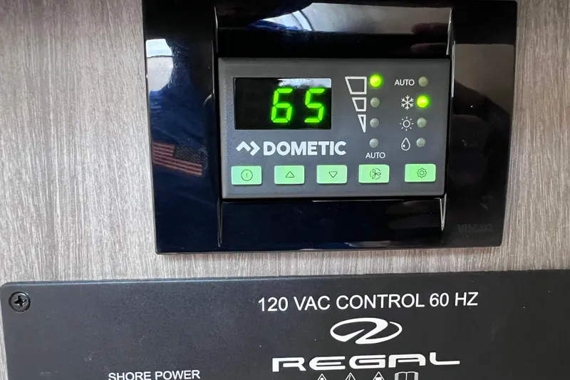Slide: The Image of Dometic control panel on 2020 Regal 26 XO boat, displaying temperature setting at 65 degrees. - 50