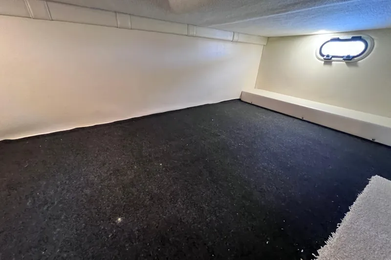 Slide: The Image of 2020 Regal 26 XO cabin interior with carpeted flooring and small window. - 54