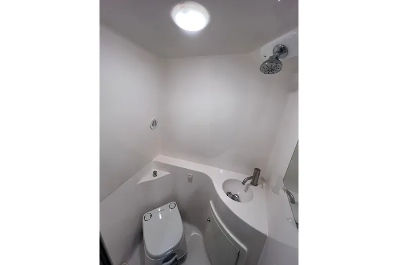 Slide: The Image of Compact bathroom in 2020 Regal 26 XO boat with shower, toilet, and sink. - 55