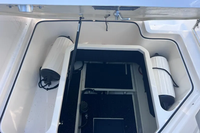 Slide: The Image of Open storage compartment in a 2020 Regal 26 XO boat, featuring organized interior space. - 56