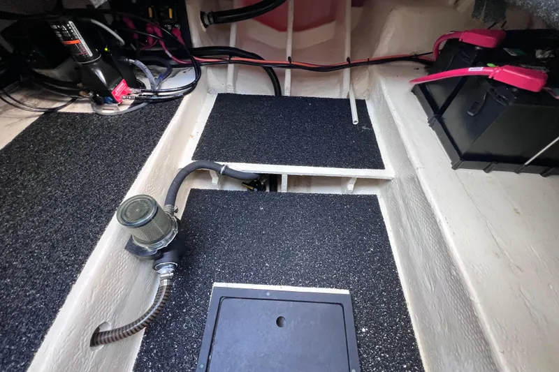Slide: The Image of Engine compartment of a 2020 Regal 26 XO boat, showing wiring and battery setup. - 57