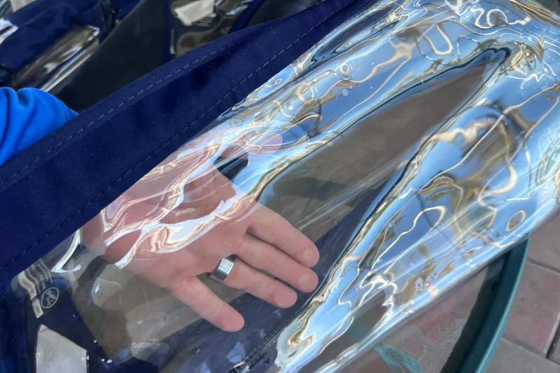 Slide: The Image of Hand touching clear plastic cover on 2020 Regal 26 XO boat. - 66