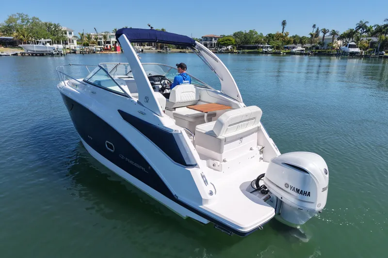 Slide: The Image of 2020 Regal 26 XO boat with Yamaha engine on a serene lake. - 7
